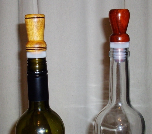 Two finished wine bottle toppers. Canary wood on the left and paduk on the right.